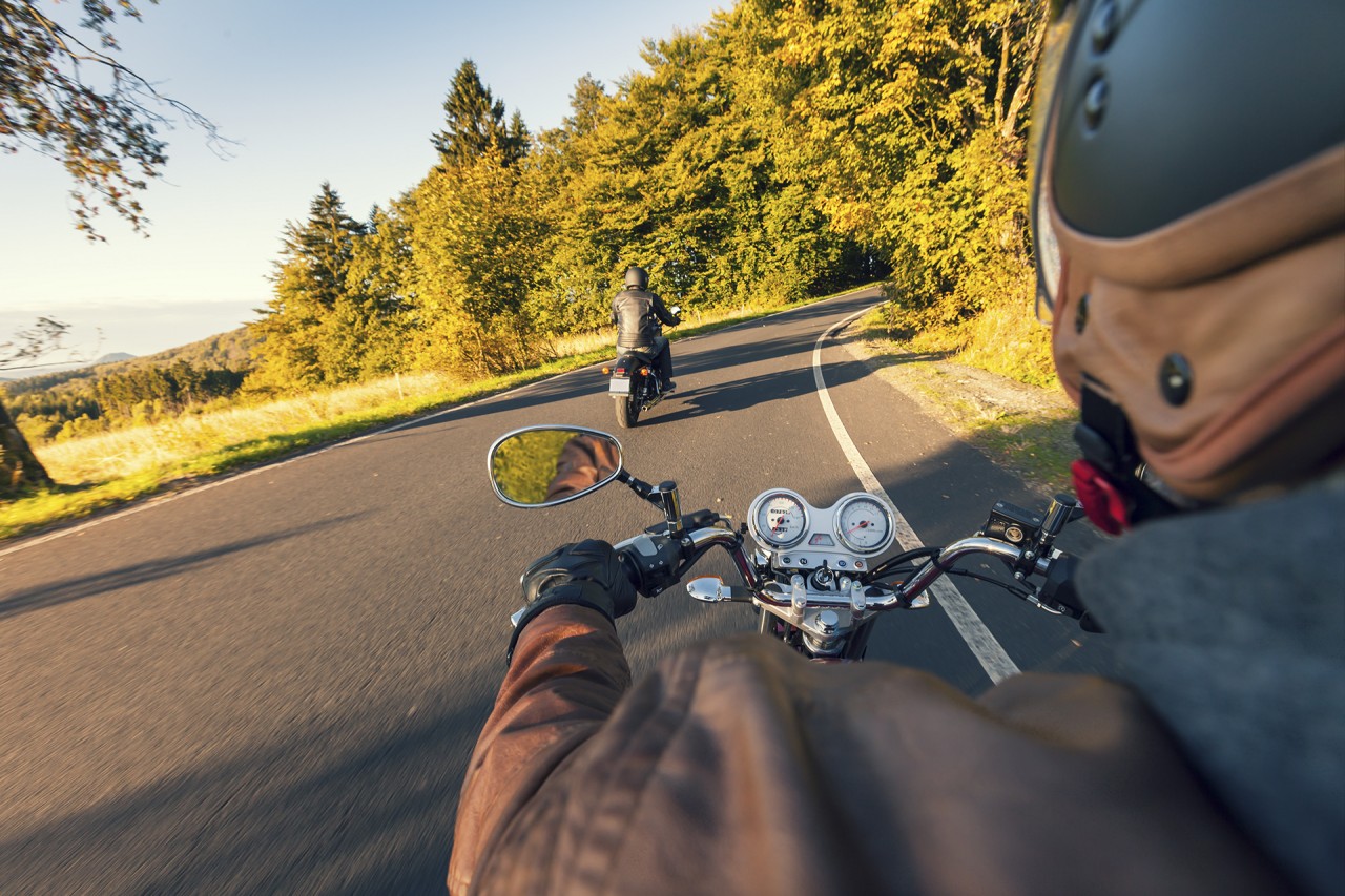 Motorcycle riders cornering through the Black Hills on the Biker Belles Ride