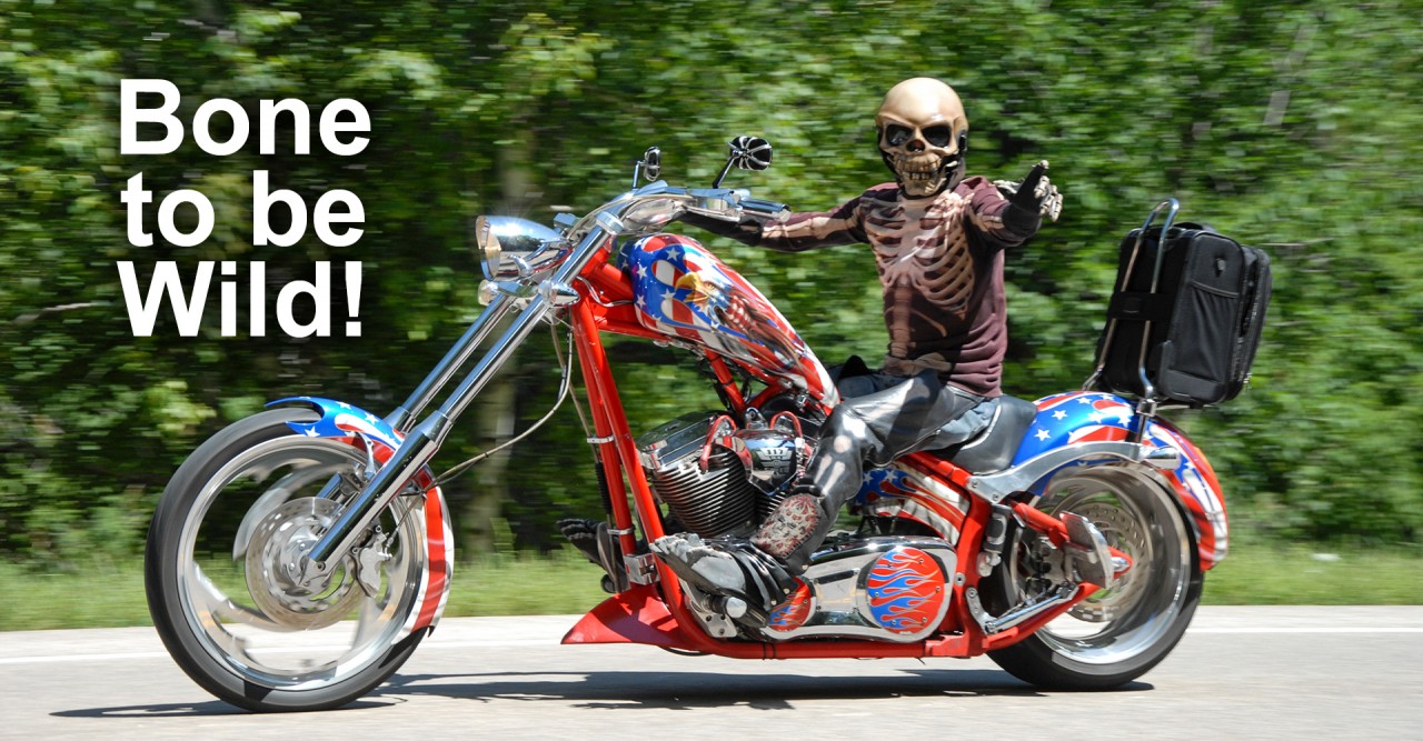 biker in skeleton outfit riding a chopper